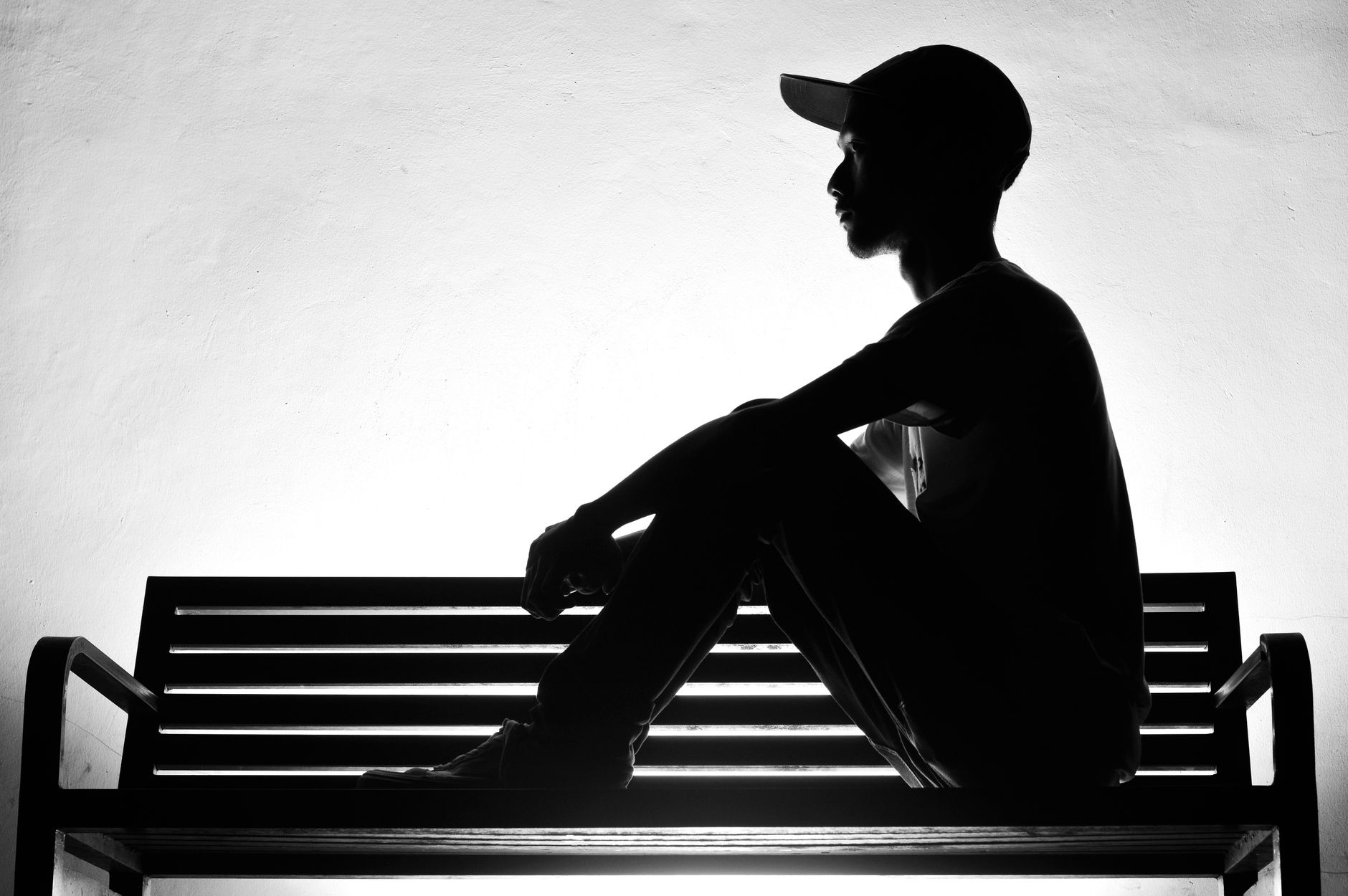 Person sitting alone on a city bench illustrating the loneliness economy UK trend