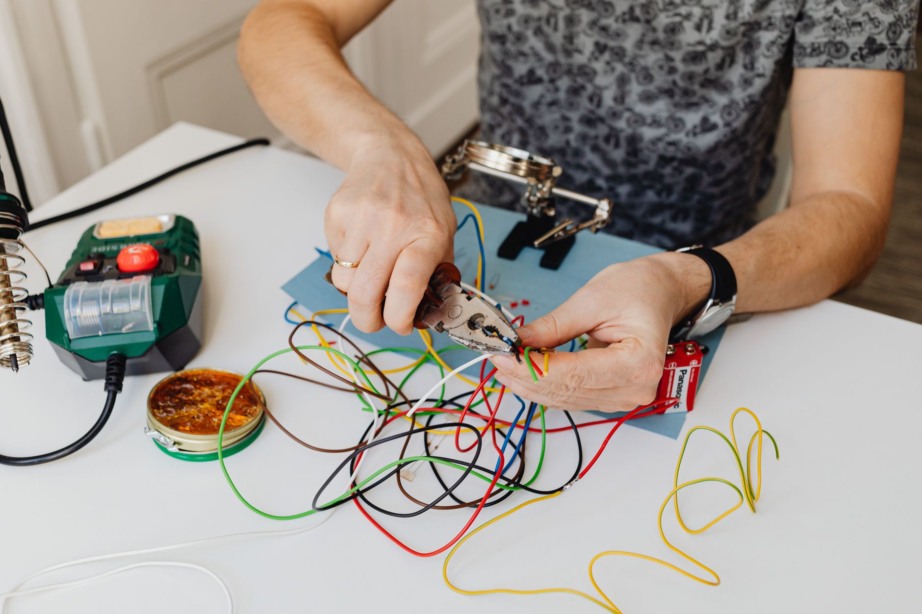 Young electrician in UK home showing graduate career shift related to uk graduate underemployment 2026
